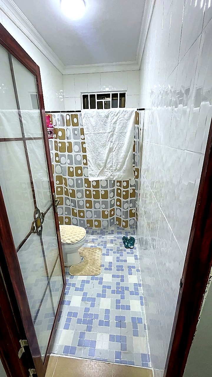 Clean tiled bathroom with shower area at Jeffston Court Hostel