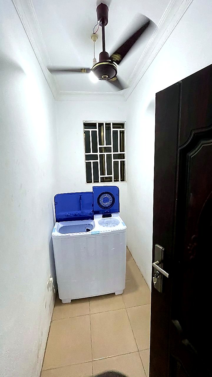 Laundry room with washing machine for Jeffston Court Hostel residents