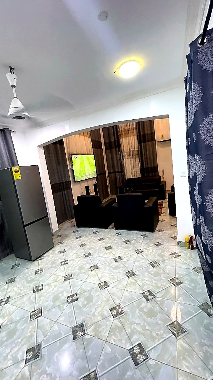 Second view of Jeffston Court Hostel lounge with seating and television